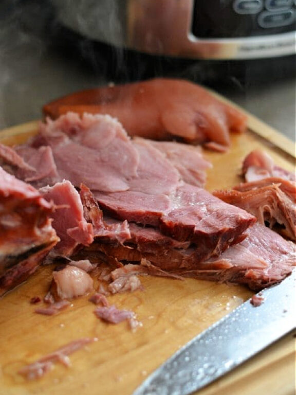 Slow Cooker Ham hot ham on a cutting board