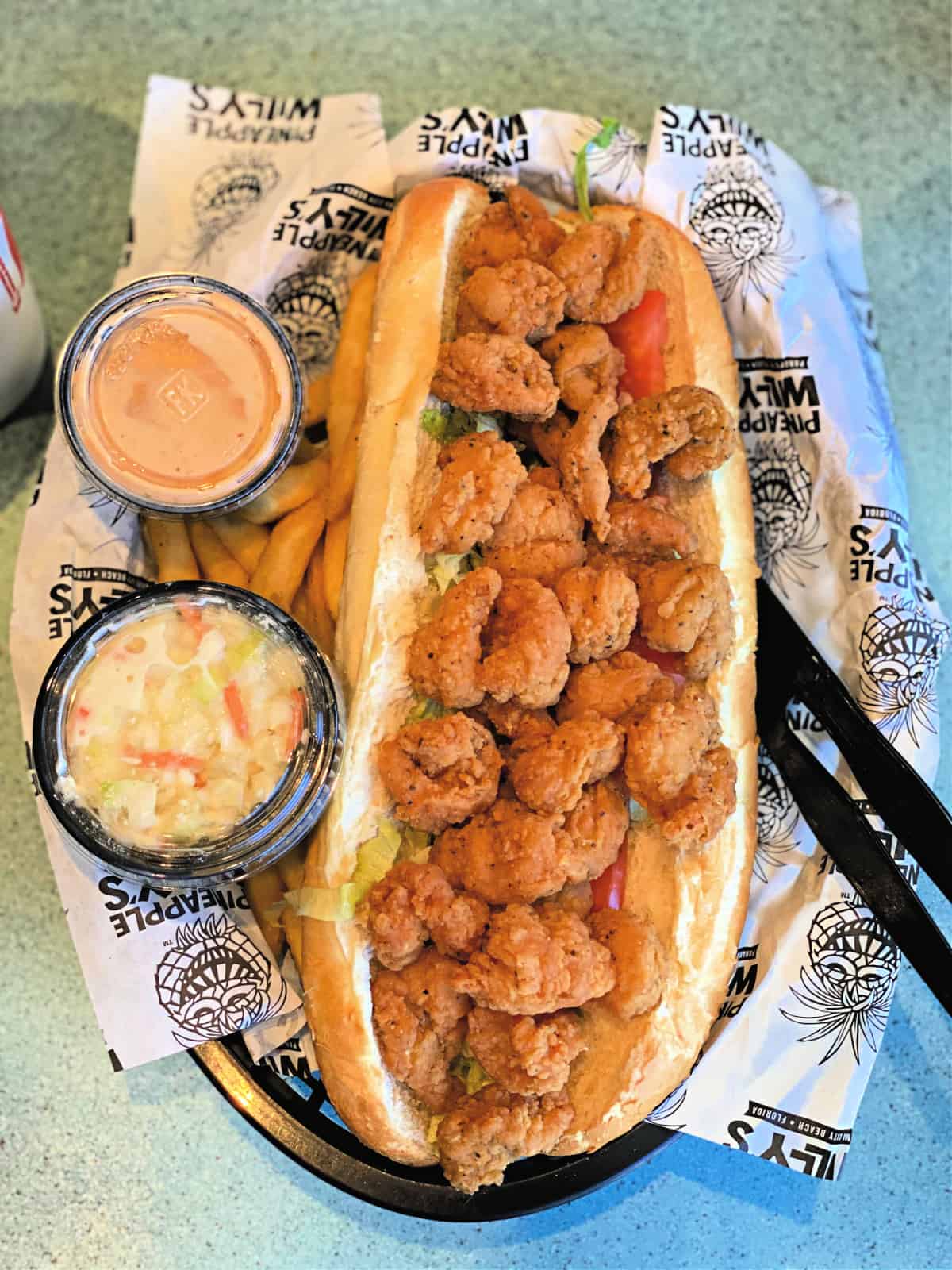 Large shrimp Po Boy sandwich and french fries.