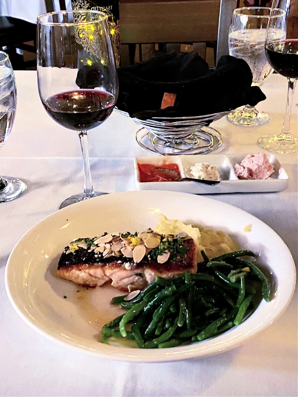 Salmon dinner with green beans and red wine.