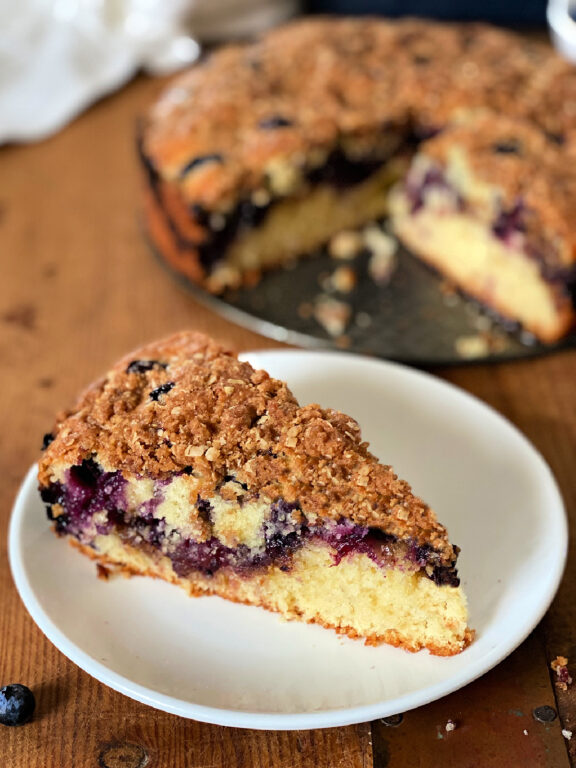 Blueberry Coffee Cake slice of blueberry coffee cake on a plate