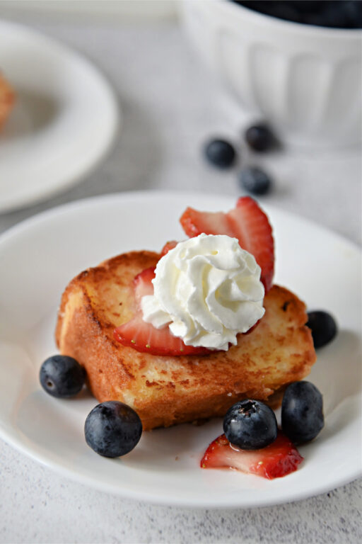 slice of angel food cake with whipped cream and berries