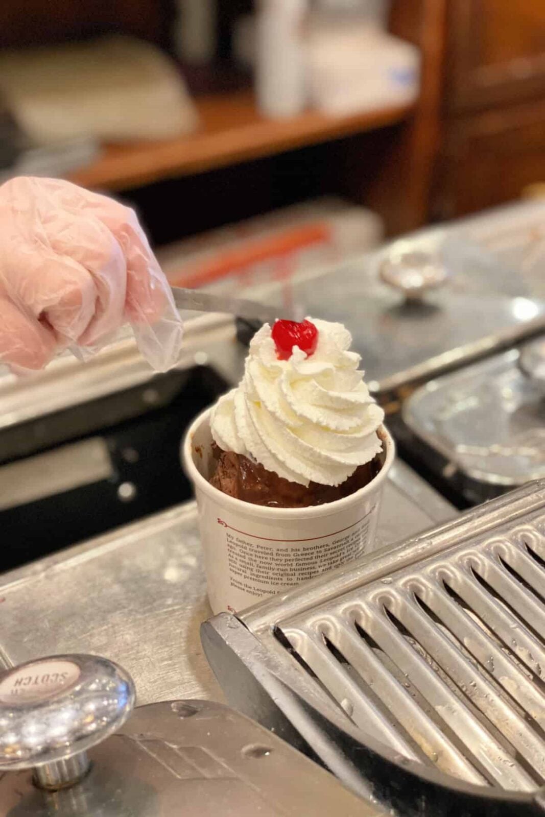 Adding cherry to a brownie sundae.