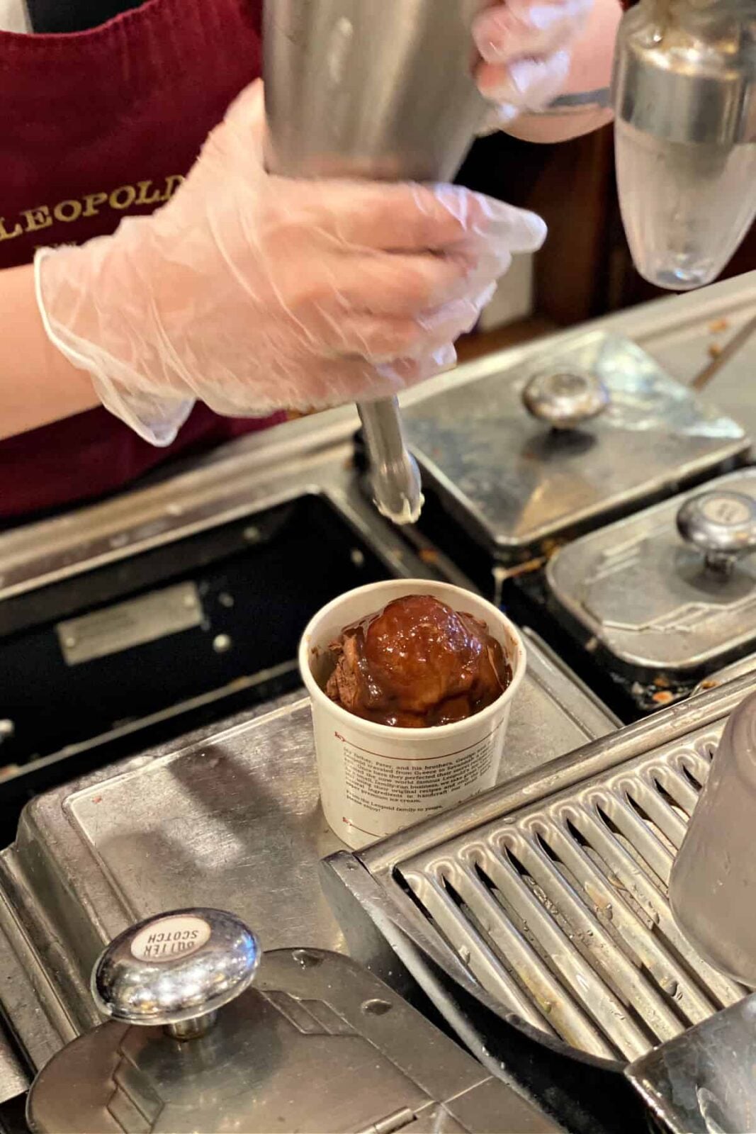 Adding whipped cream to ice cream.