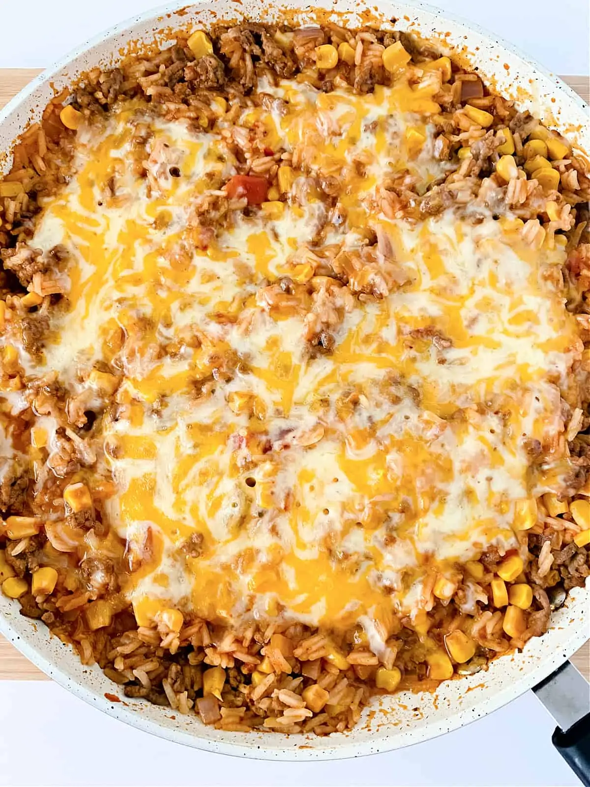 Close up view of Mexican Casserole with Rice topped with cheese.