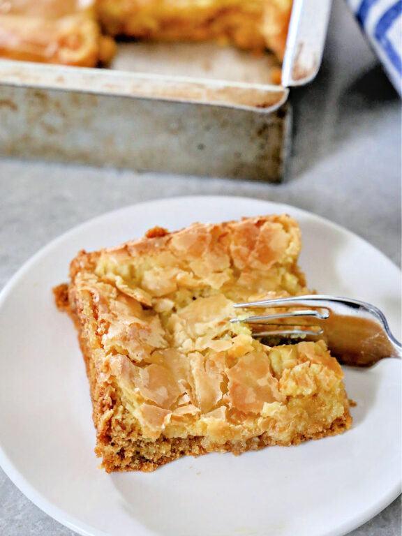 These Ooey Gooey Butter Cake squares taste just like Paula Deen's. slice of butter cake