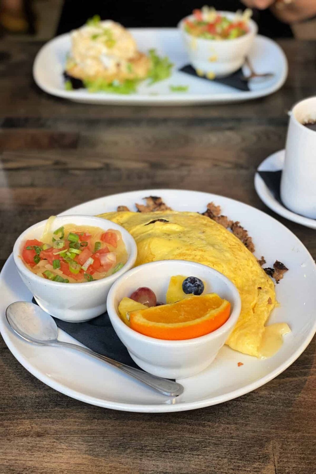 b Matthews omelet, fruit cup, and grits.