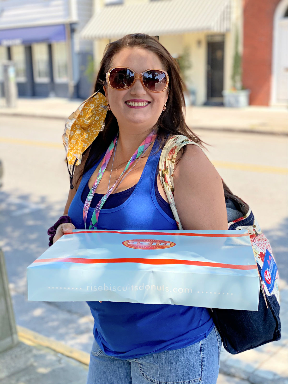 Tour guide holding a box of food.