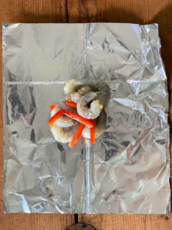 shrimp and bell peppers sitting on foil
