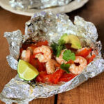 shrimp packet with red bell peppers, cilantro, avocado and lime