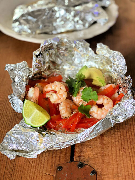 shrimp packet with red bell peppers, cilantro, avocado and lime