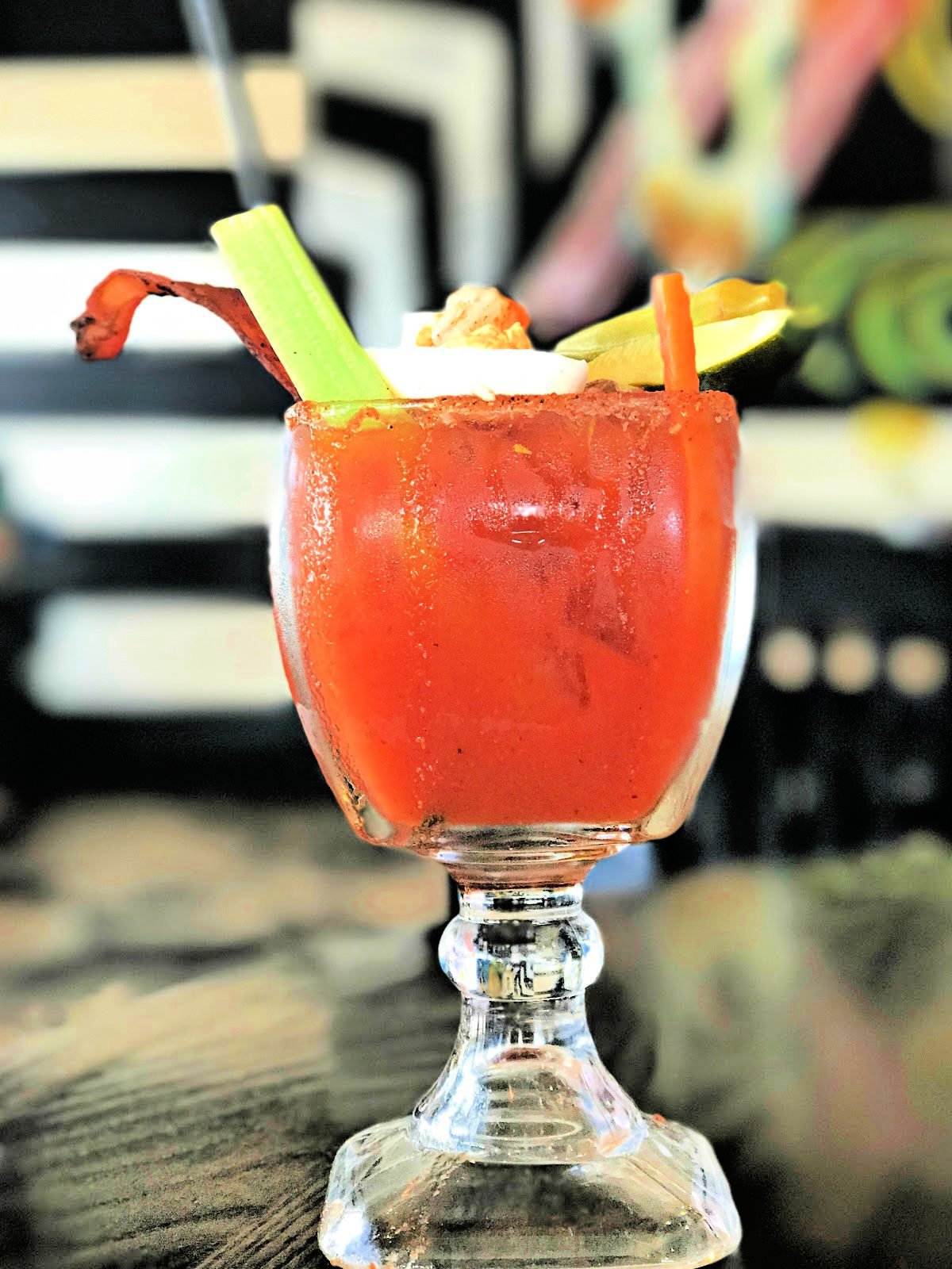 Where to eat in Gulf Shores and Orange Beach A bloody Mary with celery stalk, bacon, and pickled vegetables.
