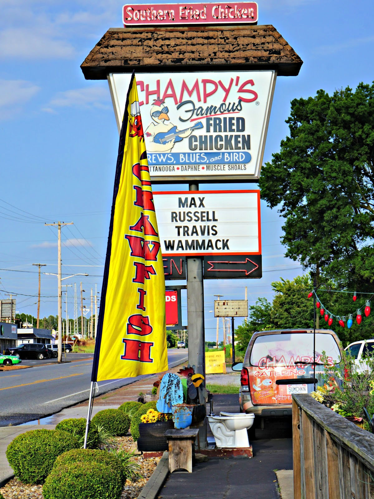 Where To Dine In the Shoals Champy's Famous Fried Chicken, Brews, Blues, and Bird sign.