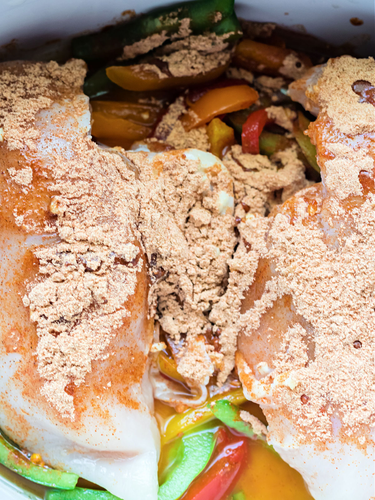 Ingredients in a slow cooker to make chicken fajitas.