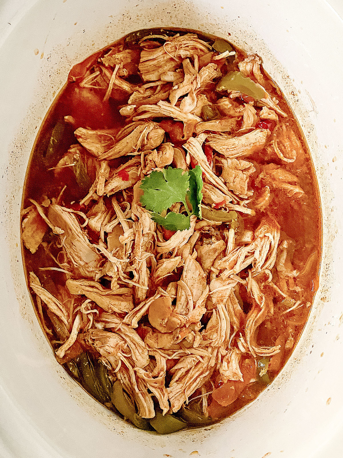 Shredded chicken fajita meat in a CrockPot.