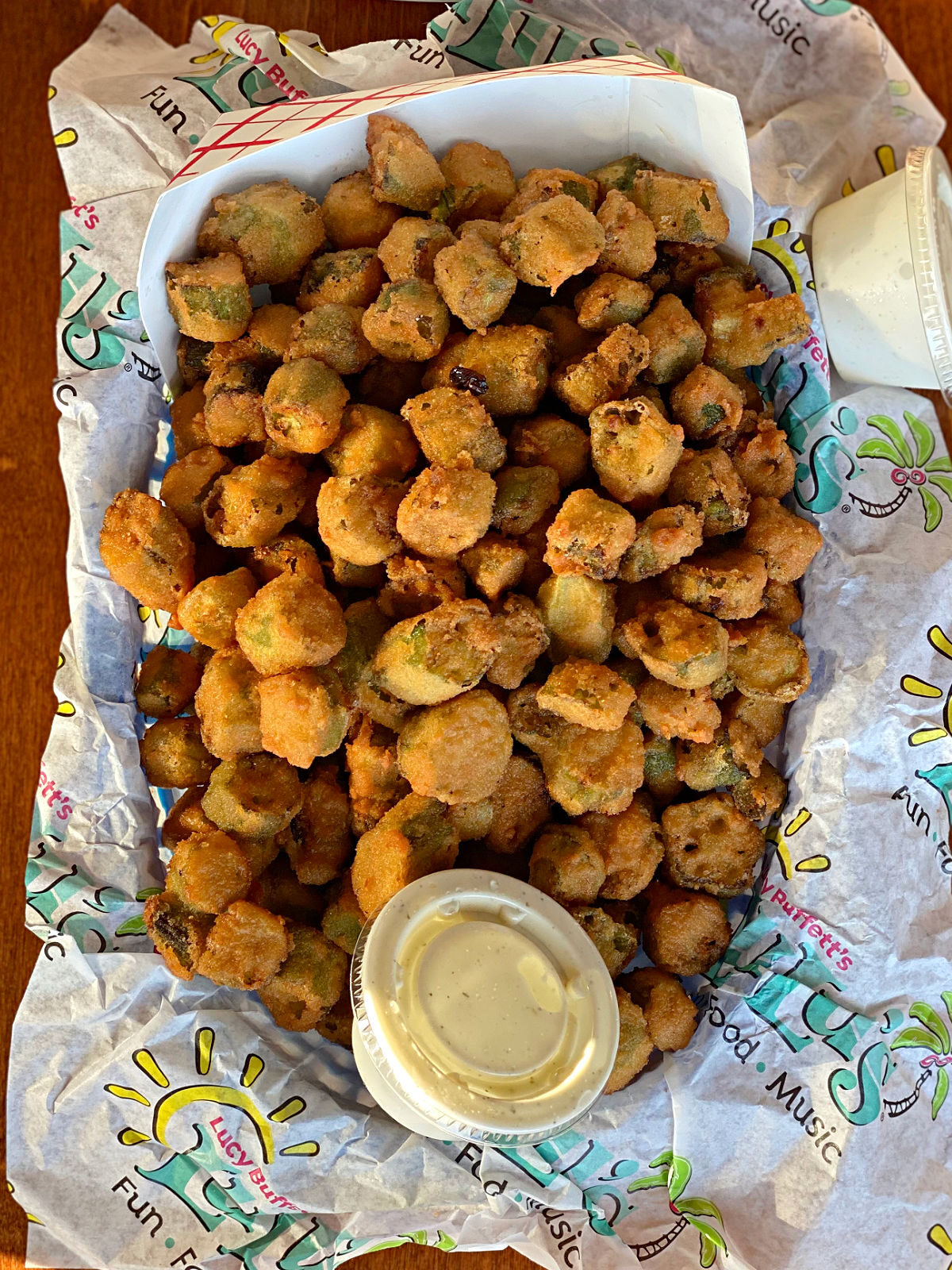 Large basket of fried okra and dipping sauce.