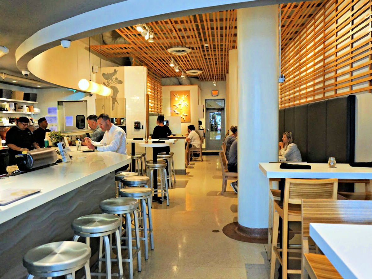 Where To Dine In the Shoals View inside Yumm restaurant with people at bar and dining at tables.