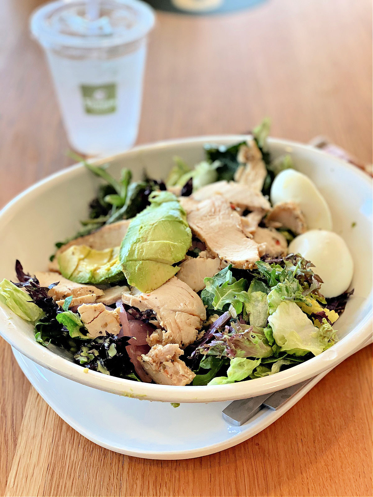 Panera's Green Goddess Salad and a cup of water.