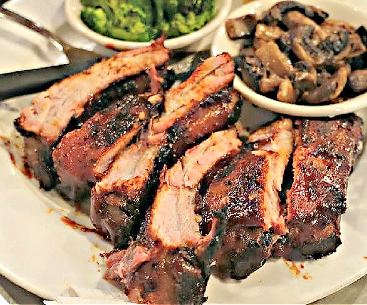 Ribs at Sing It or Wing It Plate of ribs with a side of mushrooms and broccoli.