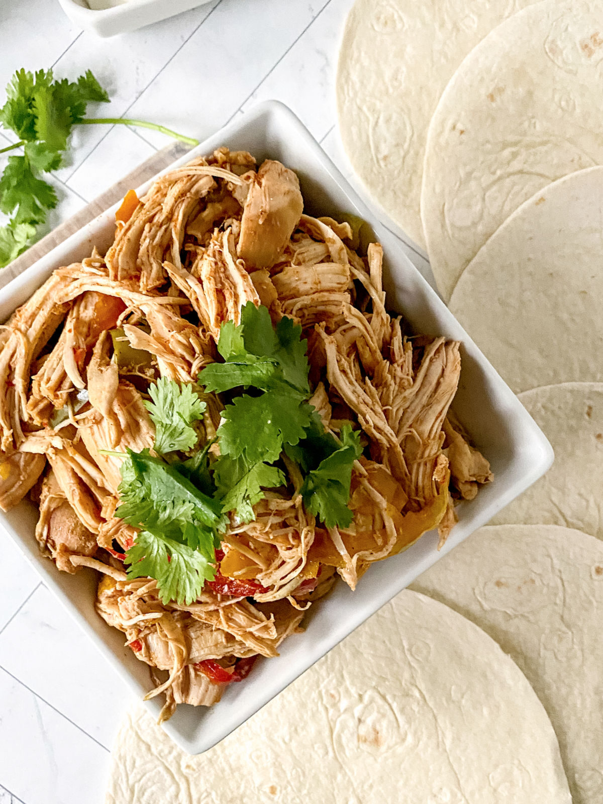 Shredded chicken fajitas meat in a bowl.