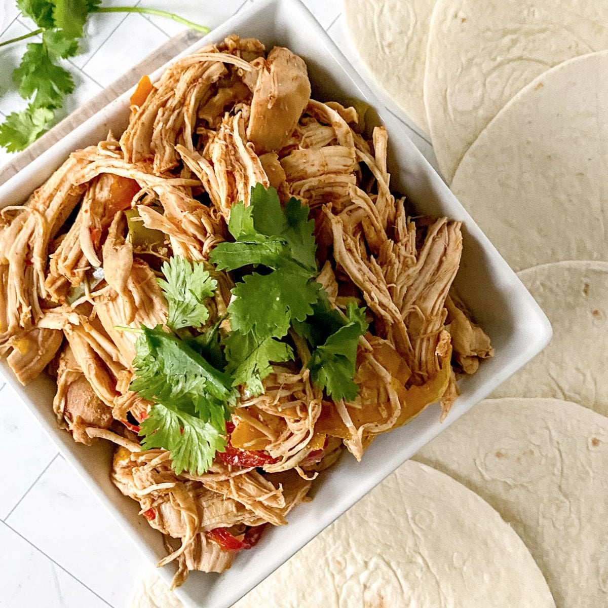 Shredded chicken fajitas meat in a bowl.