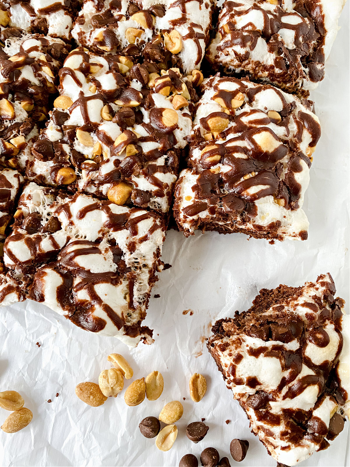 Peanuts, chocolate chips, and Rocky Road Brownies on white background.