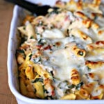 Chicken and spinach casserole in a white baking dish.