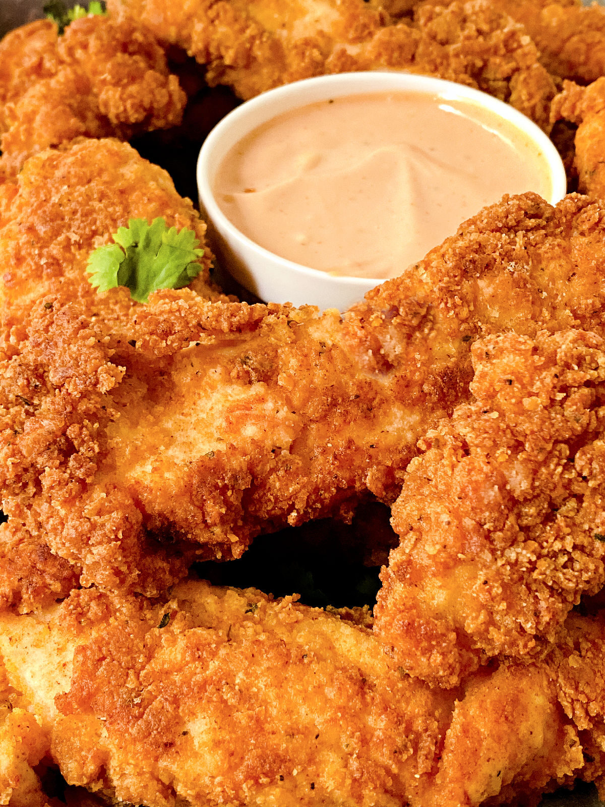 Platter of chicken tenders and dipping sauce.