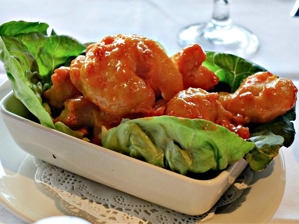 Where To Eat in Pittsburgh Small bowl of firecracker shrimp on a bed of lettuce.