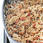 Gray non-stick skillet with rice and black-eyed peas.