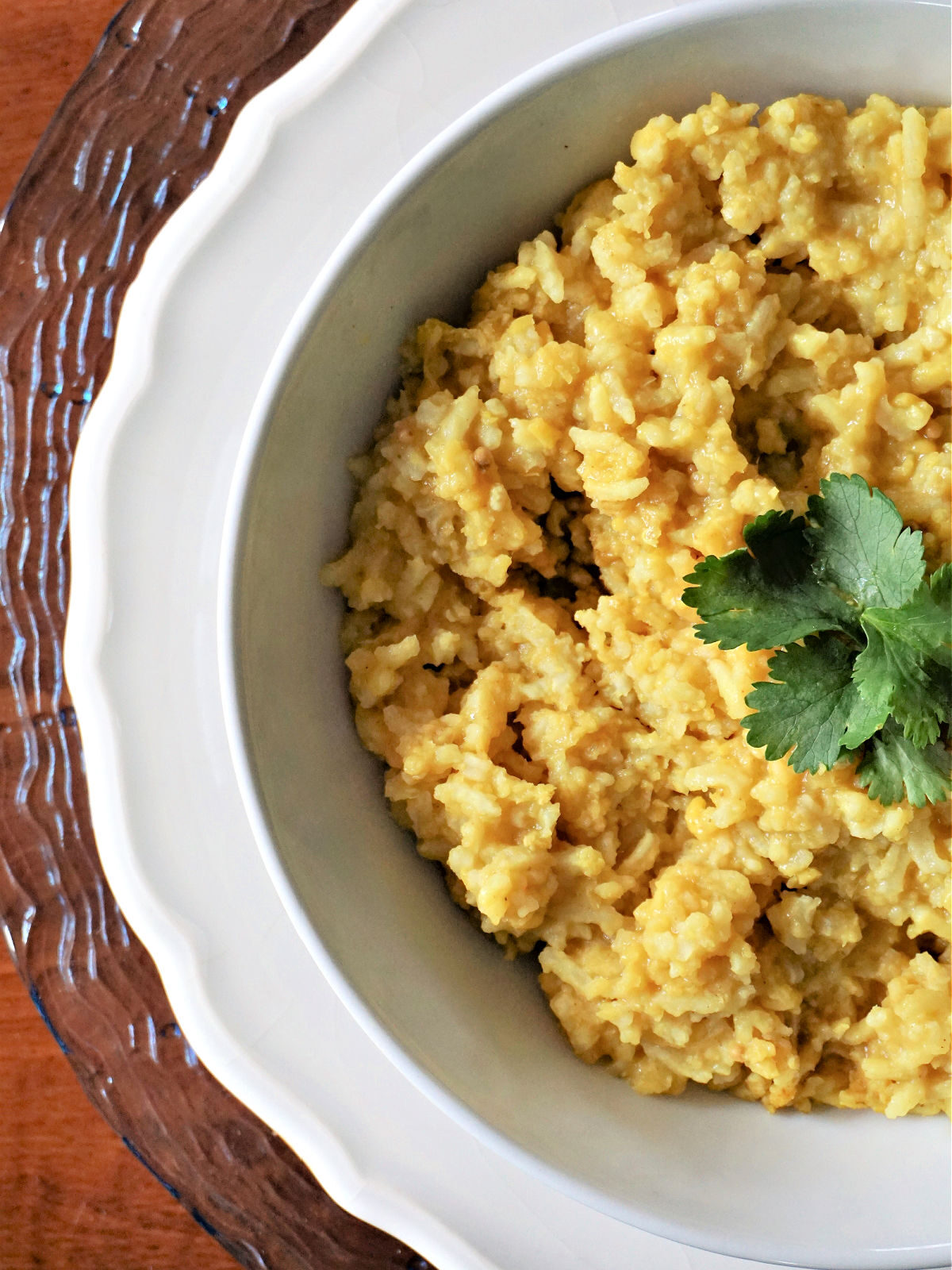 Kitchari Recipe - Ayrurvedic superfood A bowl of cooked split yellow mung dahl beans in a white bowl.