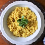 Cooked split yellow mung dahl beans topped with parsley.