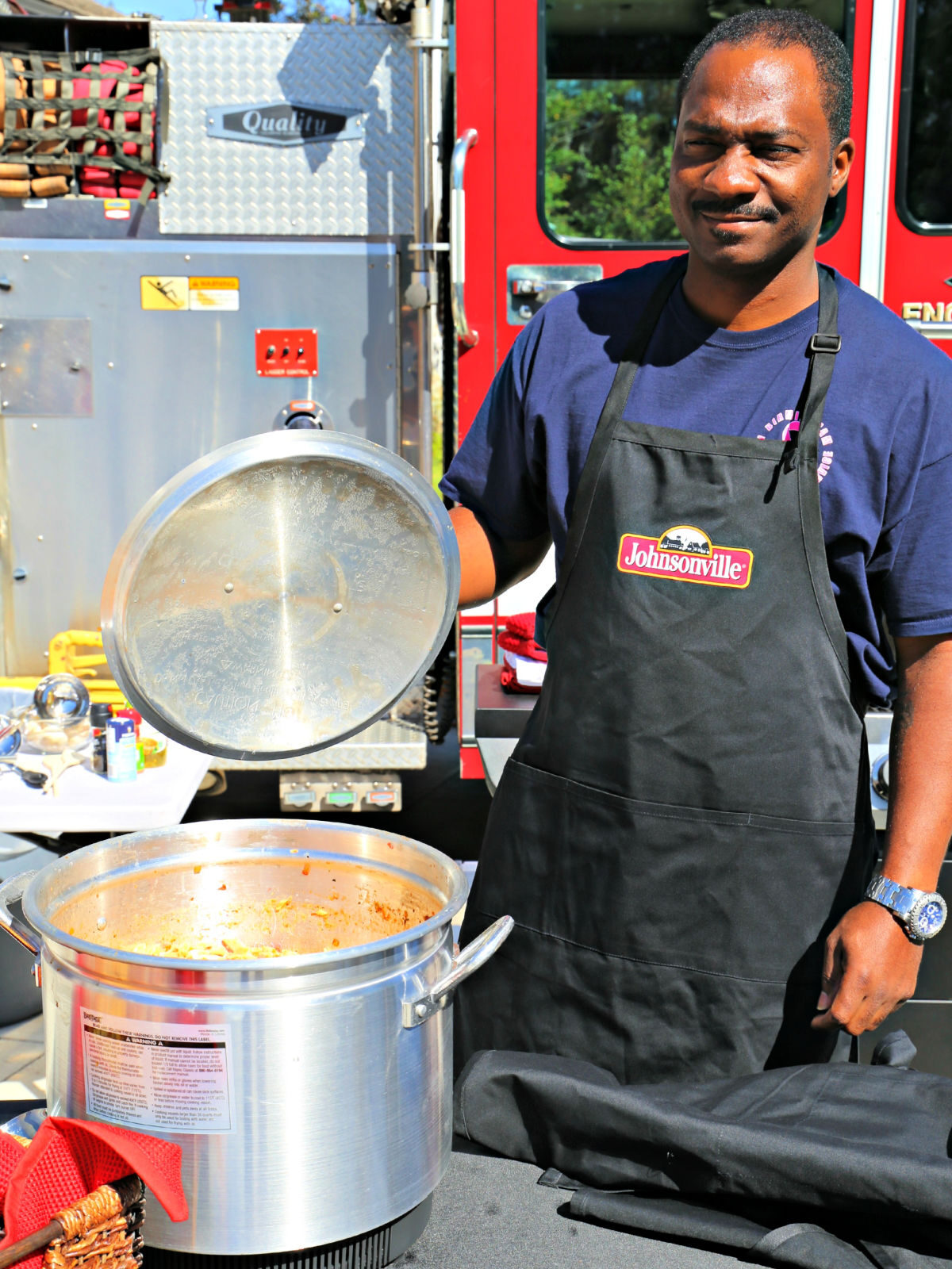 Fireman holding a lid to a stew pot.