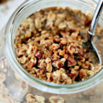 Glass jar with oats and pecan pieces.
