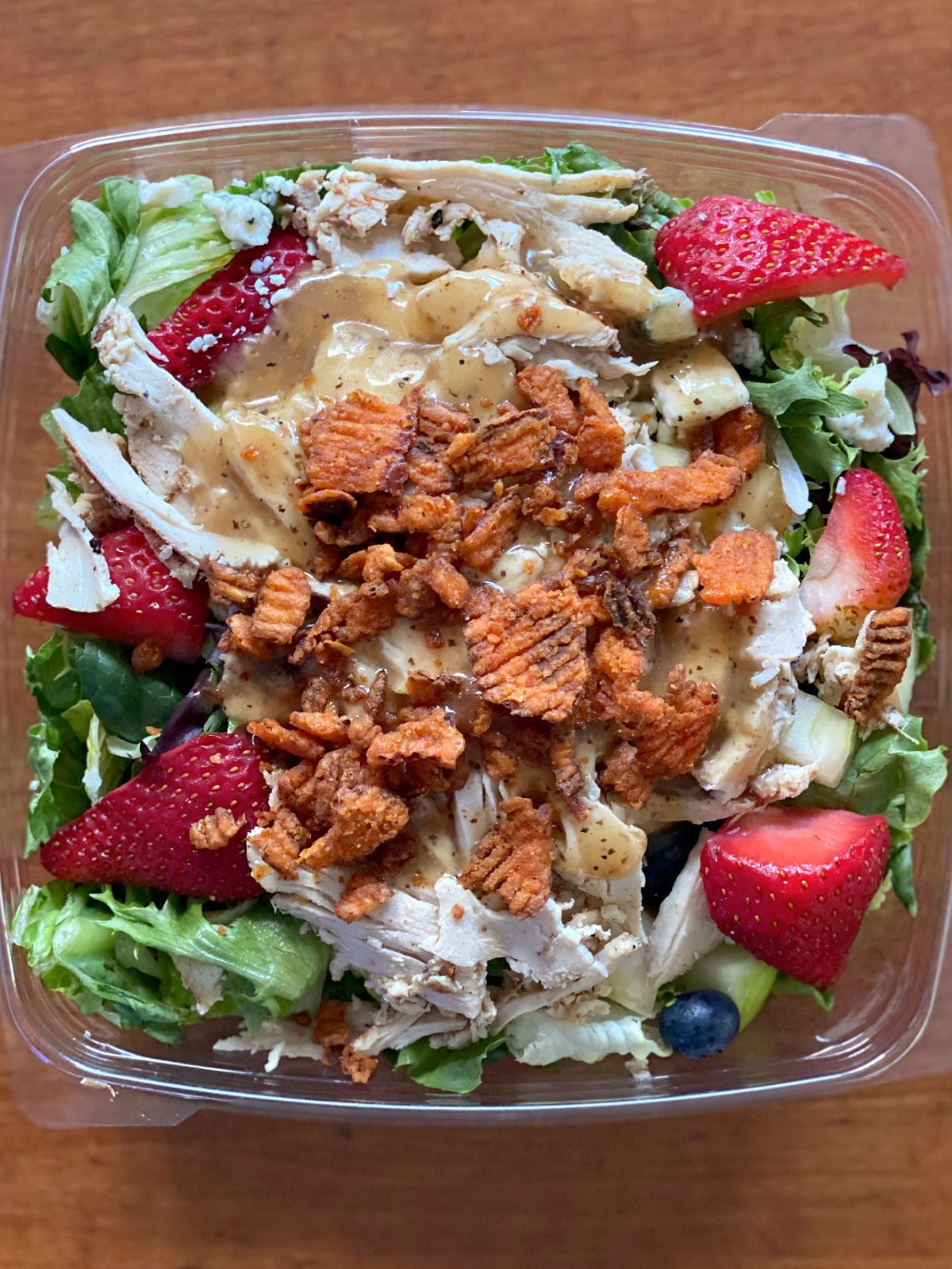 Chick-Fil-A's Market Salad with salad dressing and toppings.