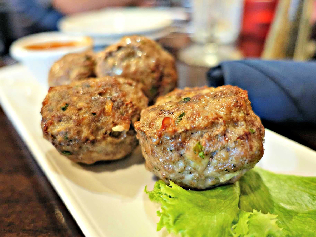 Mozzarella Stuffed Meatballs on a plate with a lettuce leaf.