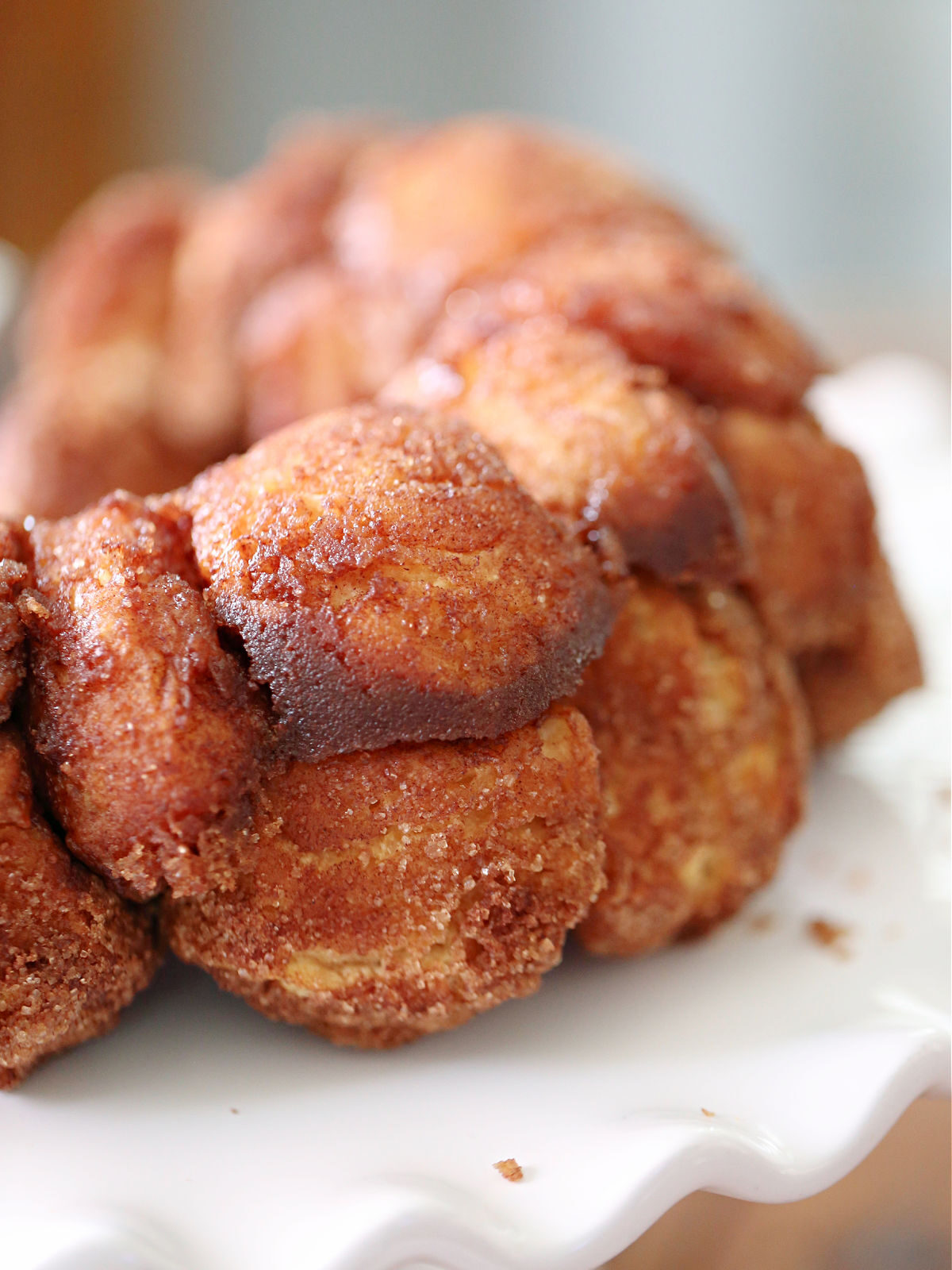Monkey bread on a white ruffled cake plate.
