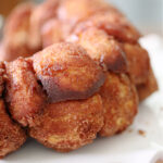 Monkey bread on a white ruffled cake plate.
