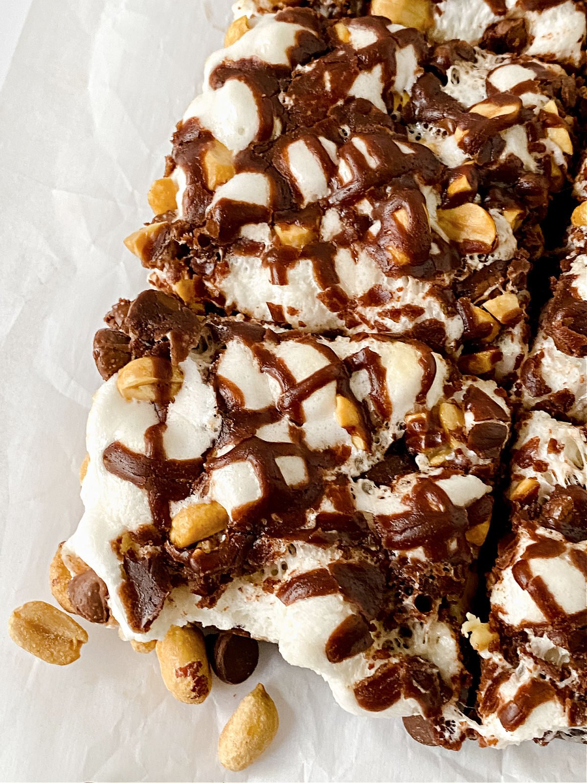 Close up of Rocky Road Brownies with peanuts and chocolate drizzle.