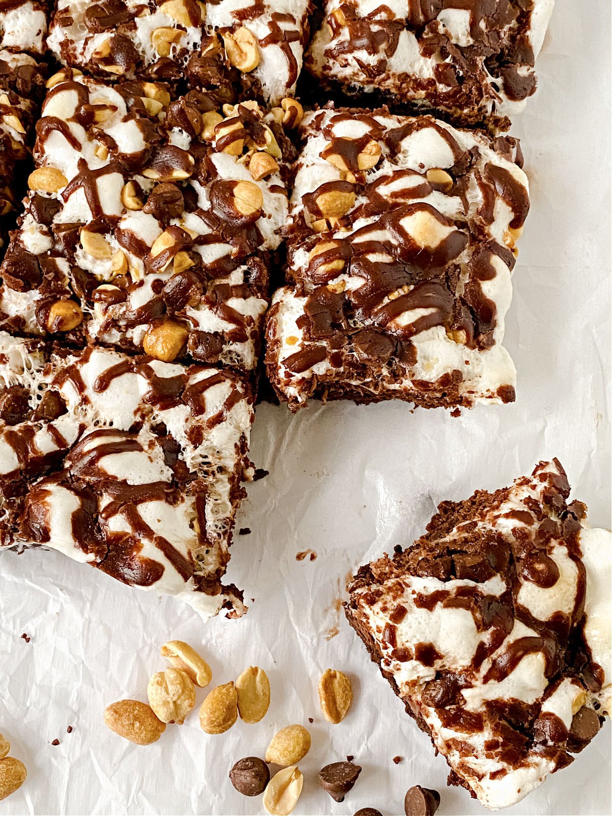 Batch of Rocky Road Brownies cut and sitting on white parchment paper.