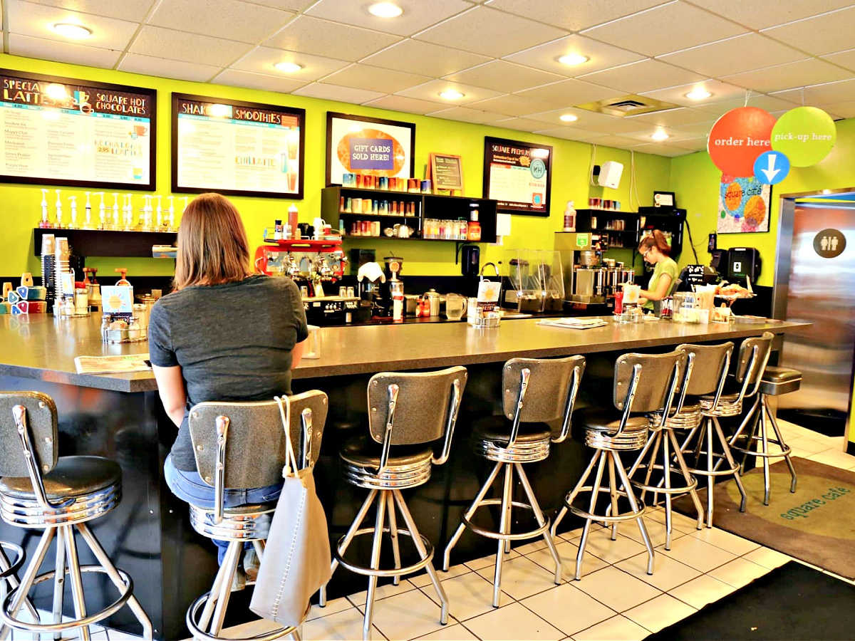 Where To Eat in Pittsburgh Woman sitting at counter at Square Cafe.