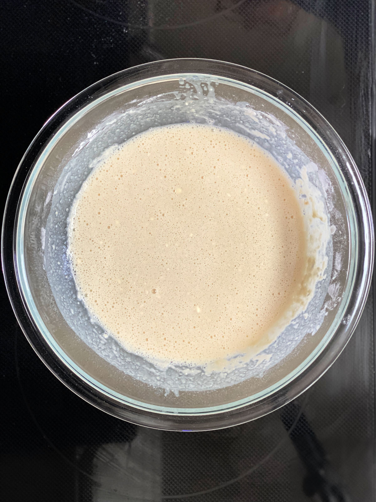 Cobbler batter in a large glass mixing bowl.