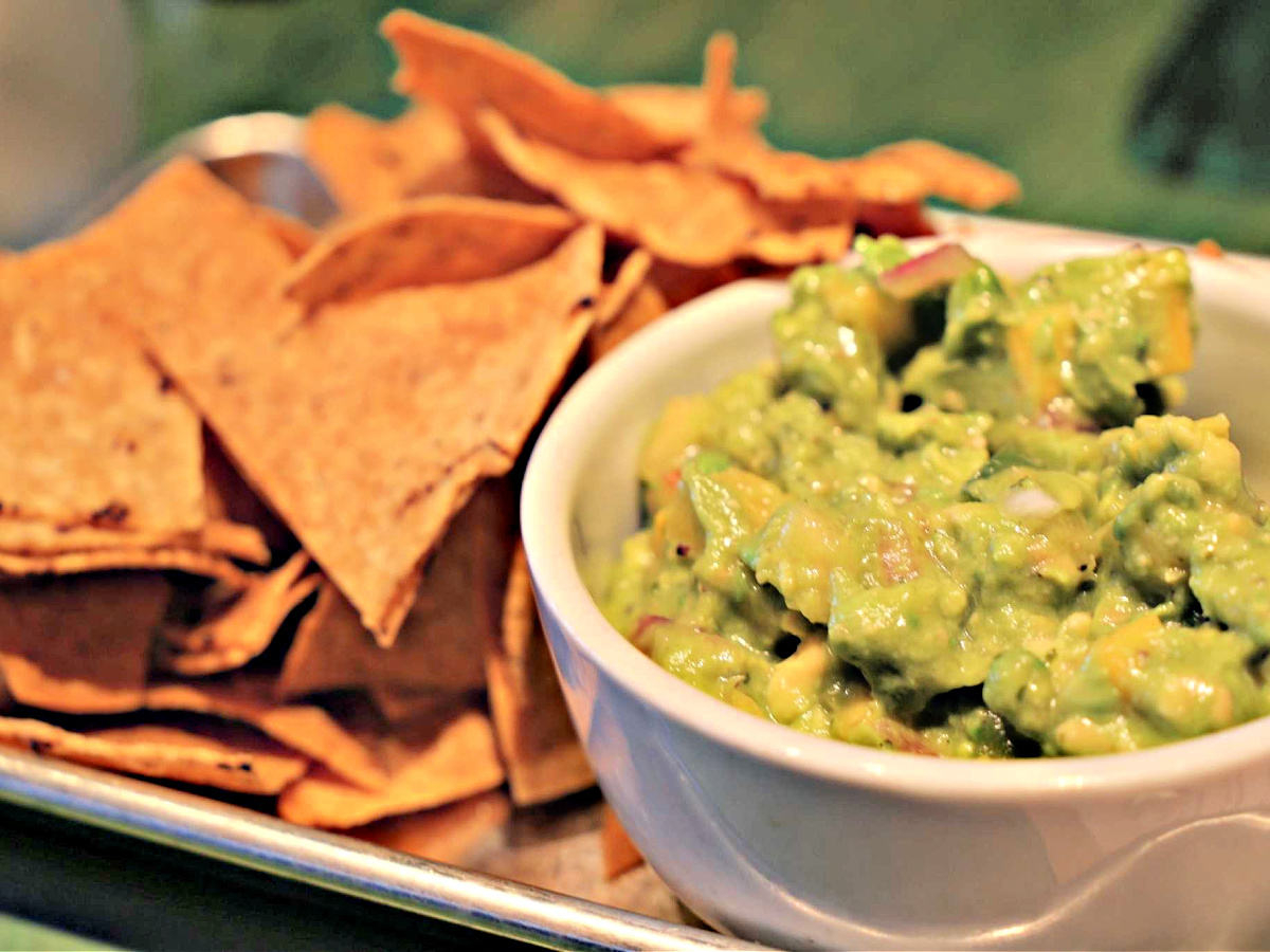 Where To Eat in Pittsburgh Bowl of fresh guacamole and a side of tortilla chips.