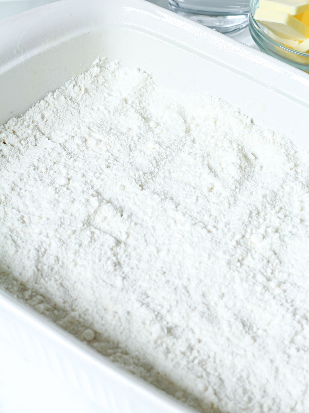 White cake mix in a white baking dish.