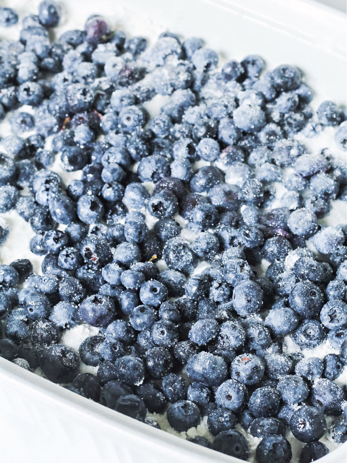 Blueberries topped with sugar in a baking dish.
