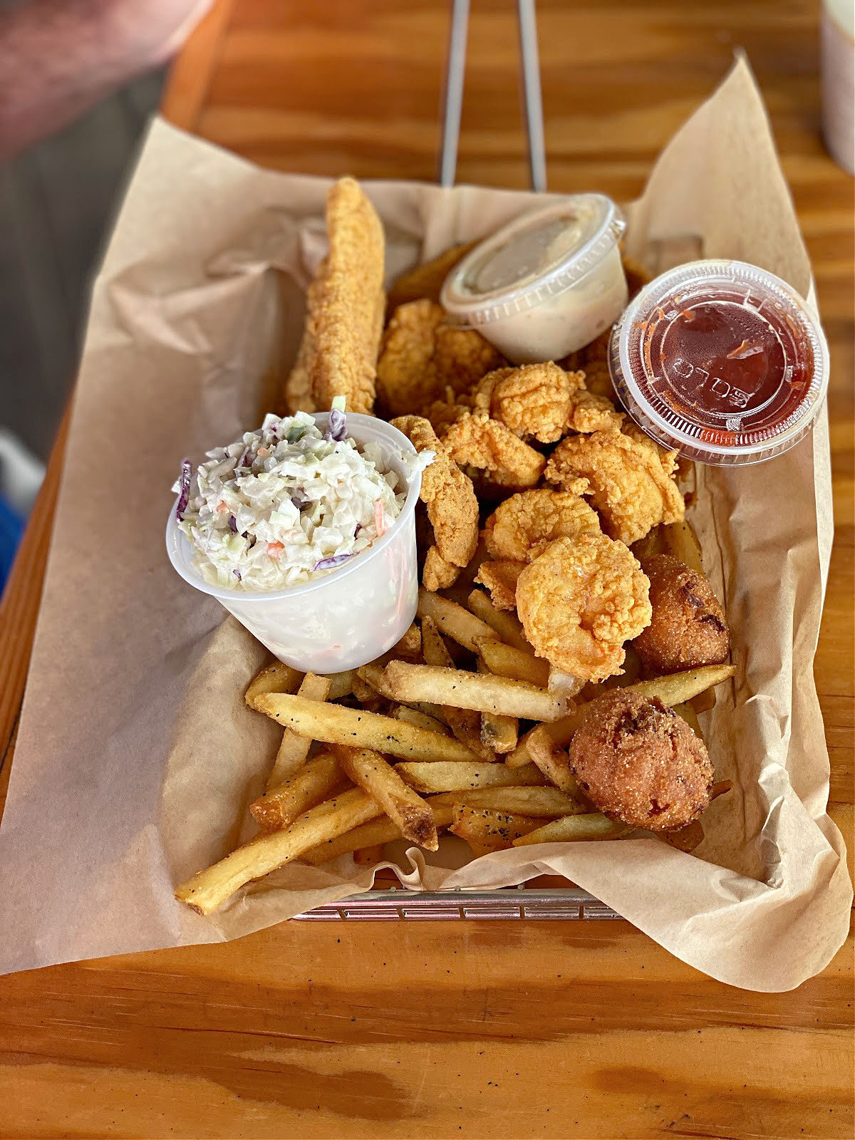 Fish and shrimp basket with French fries and coleslaw.