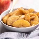 White bowl filled with fried apples.