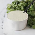 Small white bowl filled with jalapeno ranch dressing.