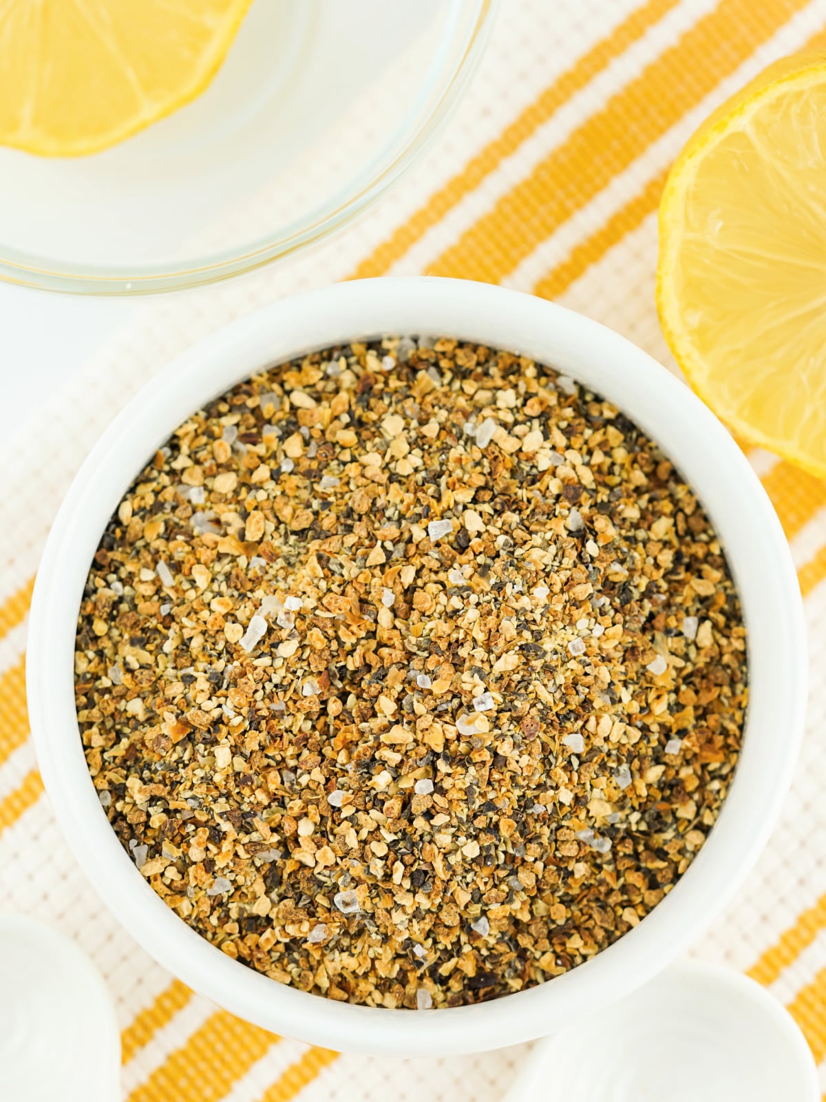 Small bowl of lemon pepper seasoning.