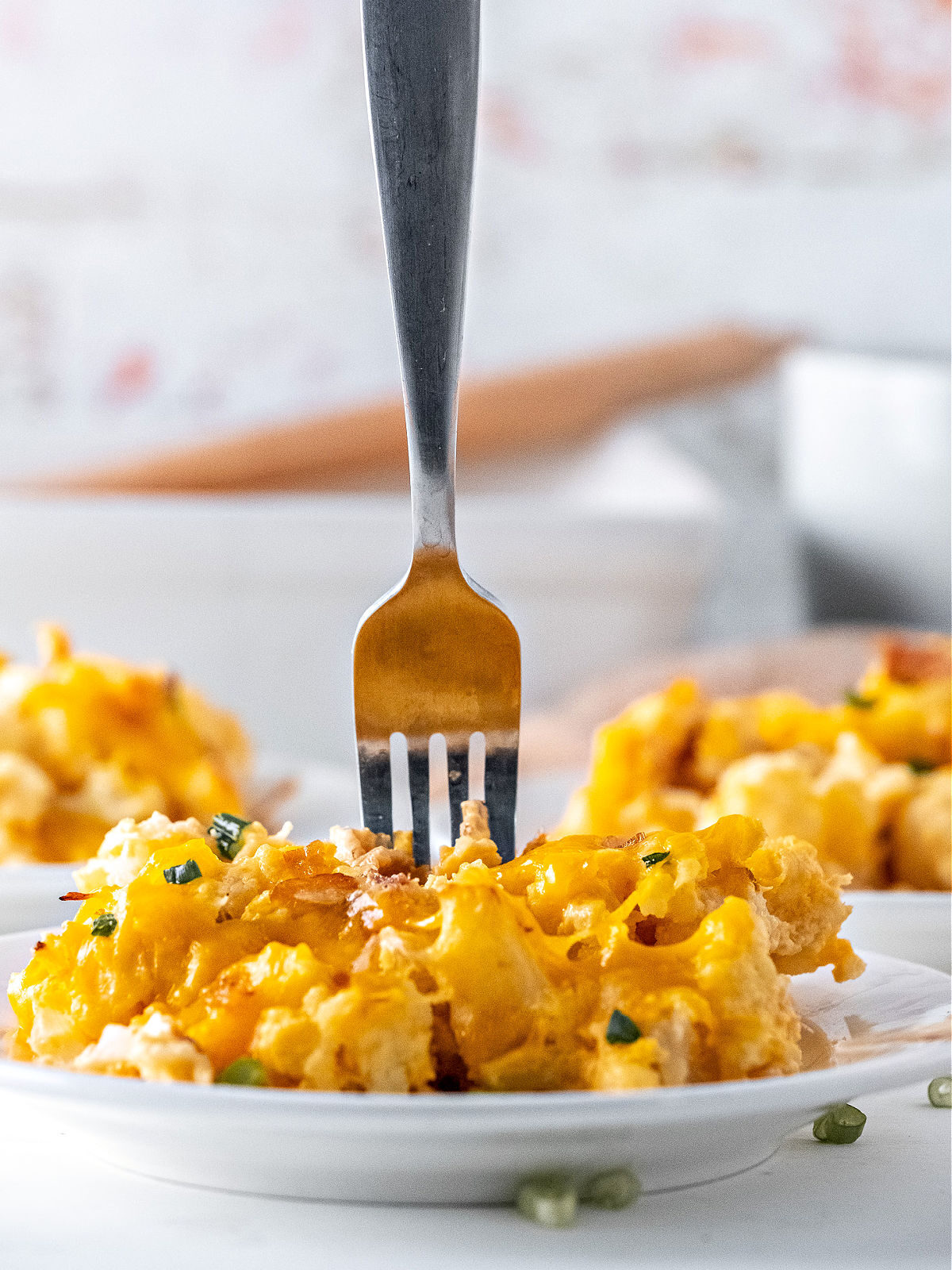 Fork digging into cauliflower casserole.