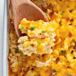 Wooden spoon with serving of cauliflower casserole.
